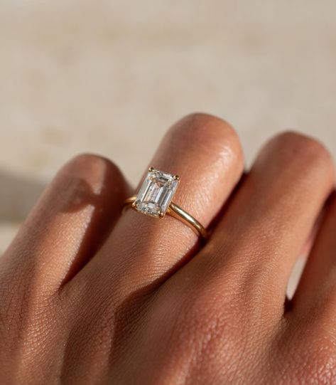 A timeless emerald cut solitaire design, with a lifted cathedral setting ✨ Details: - 2.05ct emerald cut diamond - 18k yellow gold - 1.8mm wide shank #engagementringdesign #customengagementring #emeraldengagementring #nz #aus Emerald Cut Solitaire, Cathedral Setting, Emerald Cut Diamond, Hidden Halo, Emerald Engagement Ring, Emerald Cut Diamonds, Designer Engagement Rings, Custom Engagement Ring, Emerald Ring