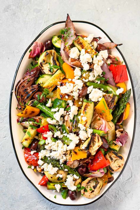 This Grilled Vegetable Salad Recipe is the absolute BEST! Kalamata olives, artichokes, and feta cheese add a Mediterranean flair. Dressing the salad while it's still warm with Lemon Garlic Vinaigrette just rounds everything out perfectly. This recipe is quick and easy, perfect for a crowd or for epic leftovers! Grilled Summer Vegetable Salad, Quinoa Grilled Vegetable Salad, Grilled Vegetable Salad Recipes, Grilled Artichoke Salad, Mediterranean Vegetable Salad, Cooked Vegetable Salad, Warm Veggie Salad, Grilled Mediterranean Recipes, Gina Livy Recipes