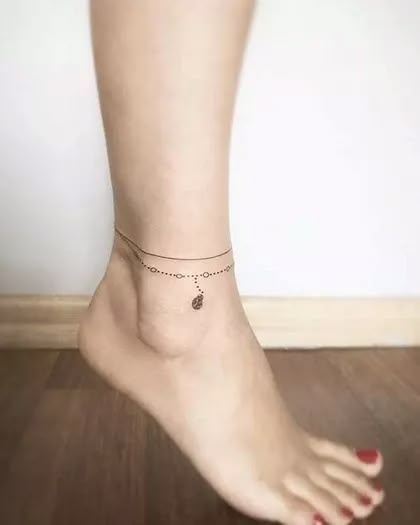 Ankle Bracelet Tattoos to make your legs look graceful Delicate Anklet Tattoo, Women Tattoos Ankle, Ankle Tattoos For Women Wrap Around Line, Tatoos Woman Ankle, Dainty Anklet Tattoo, Ladies Ankle Tattoos, Feet And Ankle Tattoos, Ancle Braclet Tattoos, Anklette Tattoo