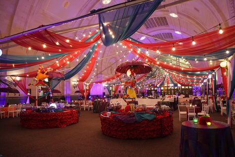 Lights and sheer draping create an elegant indoor carnival at the Great Hall, while still allowing the beauty of the barrel-vaulted ceilings to show through #jewelhospitality Indoor Carnival Decorations, Carnival Lights Decoration, Carnival Gala Theme, Carnival Dance Theme, Night Circus Decorations, Indian Carnival Theme Decor, Indoor Carnival, Indoor Festival, Circus Tent Ceiling