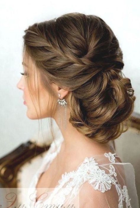 Braided Bun - 5 New Bridal Hairstyles You’ll Want to Pin Immediately - Southernliving. A loose, sideswept French braid tucks into a low bun for a look of understated elegance. #WeddingHairstylesForLongHair New Bridal Hairstyle, Bride Hairstyles Updo, Prom Hair Updo, Bridal Hair Inspiration, Long Hair Updo, Bridesmaid Hair Updo, Wedding Hairstyles Updo, Short Hair Updo, Wedding Hairstyles For Long Hair