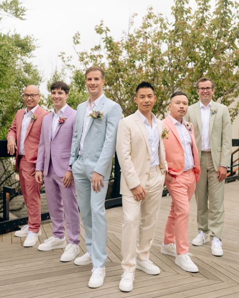 Captured the stylish vibes of Jeff and Ben’s spring wedding at the @gurneysresorts with their dapper groomsmen in colourful pastel suits. Photographer: @khatleen.photography Videographer: @bradyweddings @thebrothersgorman @angelo.rigogliosi Florist: @jennywildflower Makeup: @mariaortegamakeup Grooms’ Suits: @dior Groomsmen Suits: @indochino @indochinoweddings Grooms Man Suits Wedding Ideas, Garden Party Suit Men, Bright Groomsmen Attire, Colourful Groom Suit, Colorful Bridal Party Groomsmen, Groomsmen Pastel Attire, Groomsmen Attire Different Colors, Wildflower Wedding Groom Suit, Pastel Suits For Men Wedding