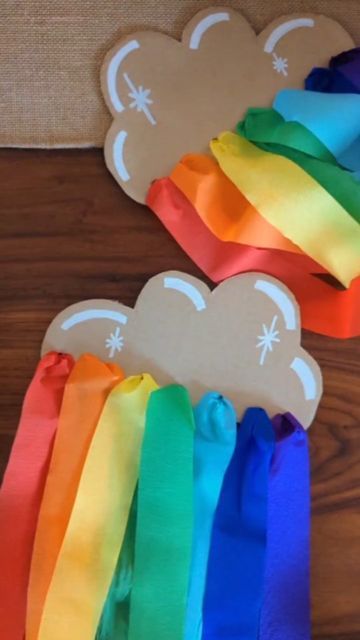 Studio Rosie on Instagram: "Cardboard Cloud Rainbow Streamers! 🌈 I had a lot of left over crepe paper streamers from Rosie's birthday party, so I repurposed them into these fun, handheld rainbow streamers! I cut out a cloud shape from cardboard and used my @makedo mini-tool to make holes along the bottom. After twisting the end of the streamer, I threaded them through the holes. These would make a fun St. Patrick's Day rainbow craft! Rosie really enjoyed threading the streamers to make her ow Cloud Rainbow Craft, Crepe Paper Rainbow, Rainbow Streamer Backdrop, Cardboard Rainbow, Rainbow Streamers, Pride Crafts, Crepe Paper Decorations, Monthly Ideas, Newspaper Flowers