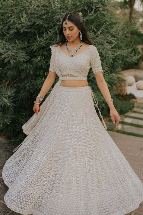 Pristine white lehenga + emerald jewellery + cutesy couple = stunning portraits! White has been an all-time classic hue but not for brides until now. In the sea of reds and pinks, thanks to Alia Bhatt’s all-white bridal look, white has emerged as a winner for bridal looks in the last few months. From benarasi beauties to chikankari stunners, white lehengas have ruled and how. Here’s a look at our favourite all-white bridal looks that we are absolutely swooning over! White Bridal Lehenga, White Engagement Dresses, Summer Outfits Casual, Simple Lehenga, White Lehenga, Latest Bridal Lehenga, Reception Outfit, Reception Lehenga, Wedding Lehenga Designs