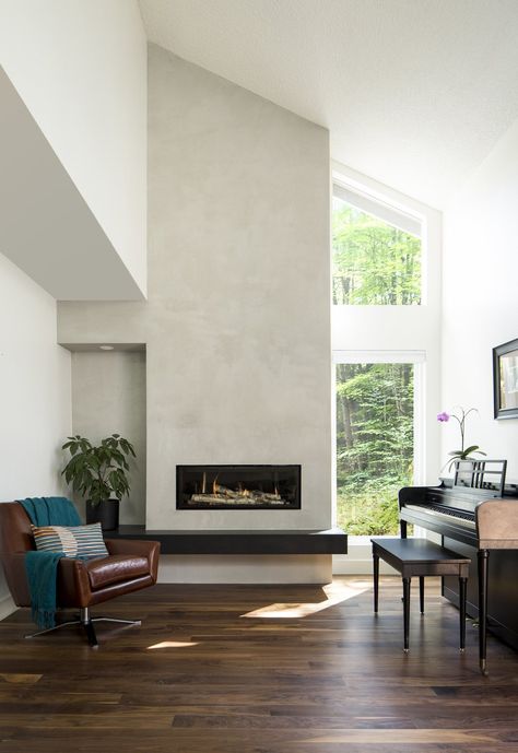 New living room fireplace, concrete finish facade, floating stone hearth, and wide plank natural walnut flooring.  Tagged: Living Room, Chair, Dark Hardwood Floor, and Gas Burning Fireplace.  Photo 1 of 8 in Maplewood Residence by Design Platform Tv Wall Design With Fireplace, Tv Wall Ideas Modern, Fireplace Concrete, Tiled Fireplace Wall, Decor Tv Wall, Design Tv Wall, Wall Decor Tv, Fireplace Modern Design, Minimalist Fireplace