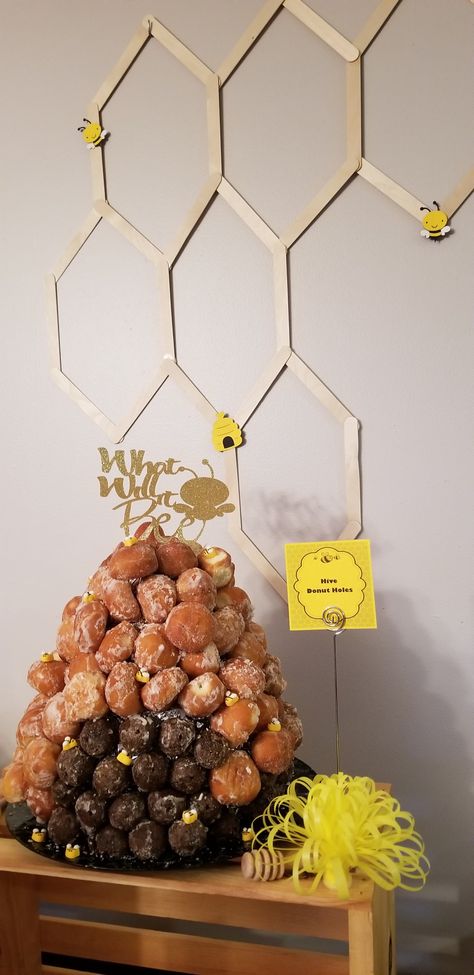 Donut hole beehive with honeycomb popsicle sticks decor for gender reveal bee themed Diy Honey Comb Decoration, Donut Hole Beehive Diy, Honey Comb Popsicle Sticks, Popsicle Stick Honeycomb Diy, Popsicle Stick Honeycomb, Honeycomb Popsicle Stick Diy, Bee Theme Food Ideas, Honey Themed Party, Bee Themed Food