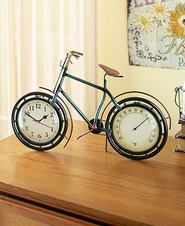 Experience a bit of nostalgia while checking the time and temperature with the Metal Bicycle Clock & Thermometer. The vintage-style bike features an analog clock inside the front wheel and a Fahrenheit thermometer inside the rear wheel. Each is protected Bicycle Clock, Metal Sculpture Artists, Eyewear Store Design, Living Room Clock, Room Clock, Rustic Inspiration, Living Room Clocks, Analog Clock, Unique Clocks