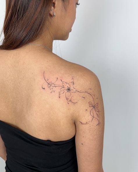 Mindori Lily Flowy ꪆৎ A beautiful Lily Flowy for Simone. We included a clover and a ribbon on either side of the blossom at her request 🤍 December and January Bookings are now open! Please send me a DM or fill out a Booking Request Form on my website to make an appointment today 🫶 #flowytattoo #flowtattoo #finelinetattoo #daintytattoo #hongdaetattoo #mindoritattoo #koreatattoo #coquettetattoo Japanese Lily Tattoo, Lily Line Tattoo, Flowy Flower Tattoo, Flowy Tattoo Design, Simple Lily Tattoo, Side Back Tattoo Women, Fine Line Lily Tattoo, Flowy Tattoo, Lilies Tattoo