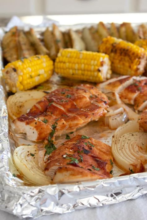 A delicious and easy meal complete with bbq chicken, corn on the cob, and potato wedges. Chicken And Corn On The Cob, Corn On The Cob And Chicken, Chicken With Corn On The Cob, Chicken Corn Potatoes, Chicken And Corn On The Cob Recipes, Corn On The Cob Dinner Meals With, Bbq Chicken Sheet Pan Dinner, Sheet Pan Bbq Chicken, Sheet Meals