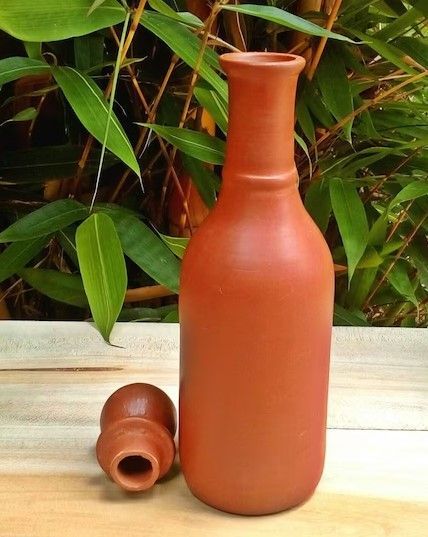 Eco-friendly Beautiful Unglazed (No any sort of paintings or varnish applied) Handmade Earthen Terracotta Clay Water Bottle. An absolute natural water cooler. Proudly made in Sri Lanka. The country is famous for tea, clay products and hand craft products. Material: Clay Weight: 625 Grams Height: 10 inches Height with Lid : 11.5 Inches Diameter : 7 Inches Capacity: 800ml earthen bottles, earthen water bottle, clay pot, milk bottle, dropper bottle, moon clay cutter, bottle caps Moon Clay, Indian Ceramics, Clay Products, Pottery Bottles, Terracotta Clay, Dropper Bottle, Craft Products, Hand Craft, Dropper Bottles