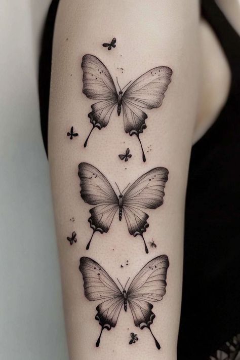 A trio of detailed black and gray butterfly tattoos on a woman’s arm, capturing a realistic style for a striking visual effect. Arm Tattoos For Women Black, Buterfluffy Tatoos, Butterfly Arm Tattoos For Women, Big Butterfly Tattoo, 3 Butterfly Tattoo, Tattoos For Women Arm, Jeep Tattoo, Butterfly Sleeve Tattoo, Realistic Butterfly Tattoo