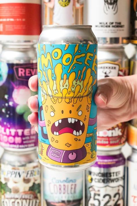 A hand holds a colorful orange and blue beer can in front of a wall of other sour beer cans. The can in focus reads "Smoofee". Beer Cans, Beer Desing, Cool Beer Can Design, Cool Soda Can Designs, Beer Can Design Packaging, Craft Beer Design, Food Logo Design Inspiration, Beer Packaging Design, Sour Beer