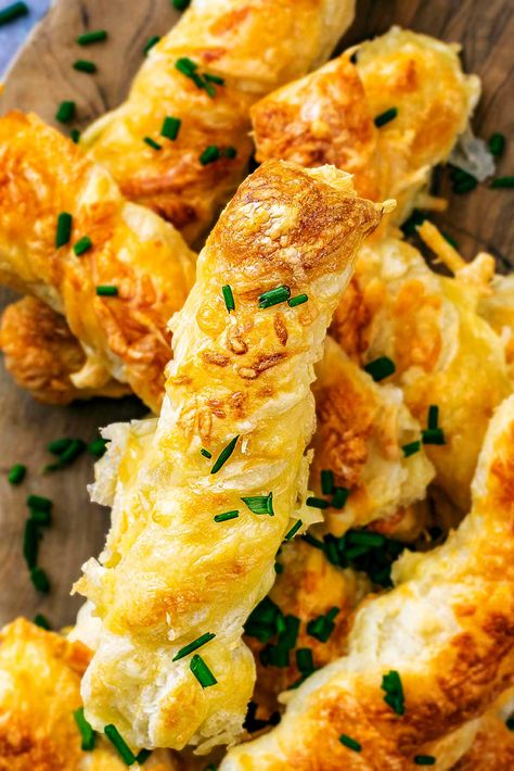 These Cheese Straws are SO easy to make, and you just need 3 ingredients. Crispy and flakey puff pastry, cheese and egg all twisted together for these delicious straws. Perfect for party food or kid's snacks and they are ready in just 20 minutes too. Easy to adapt with different flavours, these are a MUST make during the festive season. Olive Cheese Straws, Puff Pastry Cheese Sticks, Puff Pastry Cheese Straws, Cheesy Bread Sticks, Puff Pastry Cheese, Cheese Straws Recipe, Gluten Free Party Food, Cheese Twists, Gluten Free Puff Pastry