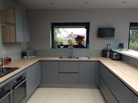 Our Kitchen... finally! Matt grey handless units, oak effect surface and glass splashback. Voxtorp Kitchen Grey, Oak And Grey Kitchen, Matte Grey Kitchen, Grey And Oak Kitchen, Grey Matt Kitchen, Matt Grey Kitchen, Shiny Kitchen, Gloss Kitchen Cabinets, White Gloss Kitchen