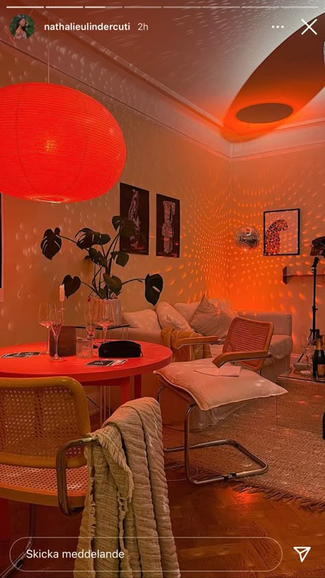 Apartment Room Lighting Ideas, Cozy Orange Living Room, Small Green Couch, Orange Apartment Aesthetic, Apartment Lighting Aesthetic, Burnt Orange Room Aesthetic, Apartment Mood Lighting, Eclectic Apartment Decorating Ideas, Retro Maximalist Decor