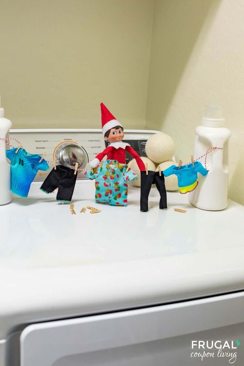 In this cute Elf on the Shelf scenario, our mischievous elf takes a break from his watchful duties to showcase his domestic side. Picture the enchanting sight of the elf delicately hanging elf-sized laundry on a candy stripe clothesline, fashioned from red and white baker's twine tied to miniature detergent bottles in the laundry room. It's a tiny but heartwarming touch to add a sprinkle of festive magic to your holiday traditions. New Elf ideas daily plus free Elf on the Shelf printables. Elf Laundry Room, Elf On The Shelf Laundry Room, Elf Printables, Mom Coupons, Red Guy, Detergent Bottles, Money Saving Mom, An Elf, Bakers Twine