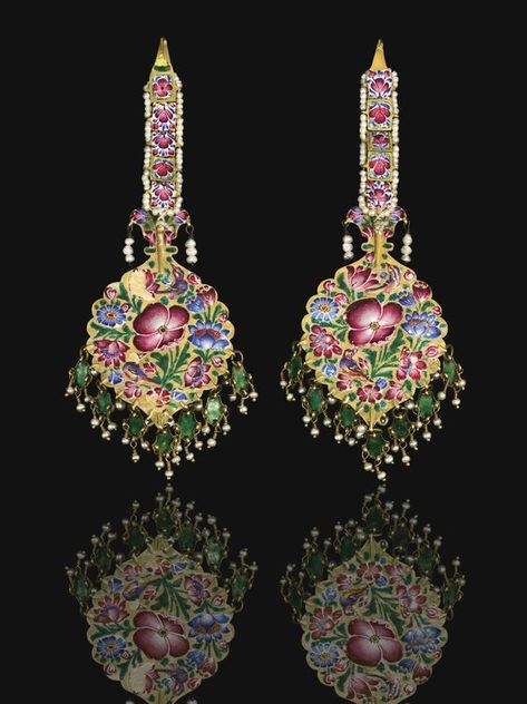 Qajar gold, enamelled and jewelled earrings/hair pendants, Persia, 19th century ~ each polychrome enamelled pendant set with a central gem-set flowerhead including rubies and emeralds, with hanging palmettes and seed-pearls, surmounted by a linked chain decorated with enamelled flowers and gem-set within a seed-pearl border, the reverse with ornate bird and floral design Historical Jewellery, Jewelry Post, Ancient Jewelry, Gold Earrings Designs, Old Jewelry, Churidar, Enamel Jewelry, Ethnic Jewelry, Antique Jewellery