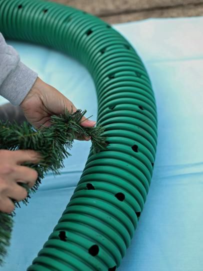 How to Make an Oversized Christmas Wreath | HGTV Christmas Wreath Designs, Outdoor Christmas Wreaths, Large Christmas Wreath, Hgtv Shows, Drainage Pipe, Front Porch Christmas Decor Ideas, Porch Christmas Decor Ideas, Christmas Decor Ideas Diy, Faux Greenery