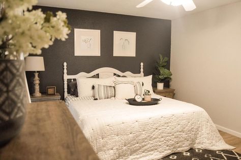 The two-toned combination of soft gray and bold black is applied to the walls of this cozy bedroom. The graceful white bed creates a lovely bedtime vibe. The rich wood elements from the floor and stands add a nice rustic touch to the space. Grey White And Black Bedroom, Grey Black And White Bedroom, White And Black Bedroom Ideas, White And Black Bedroom, Black Panel Bedroom, Black And White Bedroom Ideas, Black Bedroom Ideas, Black Shiplap, Natural Wood Bed