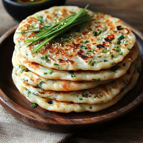 🥳 Crispy and savory Korean Scallion Pancakes are the perfect treat for any meal—simple to make and packed with flavor! 🥞🌿 #ScallionPancakes #KoreanSnacks Korean Scallion Pancakes Ingredients: All-purpose flour (1 cup) Hot water (1/2 cup) Scallions, chopped (1/2 cup) Salt (1/2 tsp) Vegetable oil (for frying) Instructions: In a bowl, mix flour and hot water to form a dough. Knead for 5 minutes. Roll out the dough thinly and sprinkle with chopped scallions. Fold and roll the dough again, the... Korean Scallion Pancake, Korean Snacks, Scallion Pancakes, Twisted Recipes, Savory Pancakes, Pancakes Ingredients, Trending Recipes, Food Obsession, Tasty Dishes