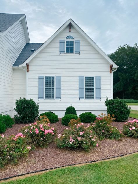 Our Home Exterior Makeover – Pop of Pippi Cream House Blue Shutters, Southern Cottage Exterior Paint Colors, White Cottage With Shutters, Vinyl Siding Homes Exterior, Painted Brick Beach House Exterior, Vinyl House Exterior, Scalloped Exterior Trim, White House Blue Shutters French Country, Vinyl Siding Ideas Exterior