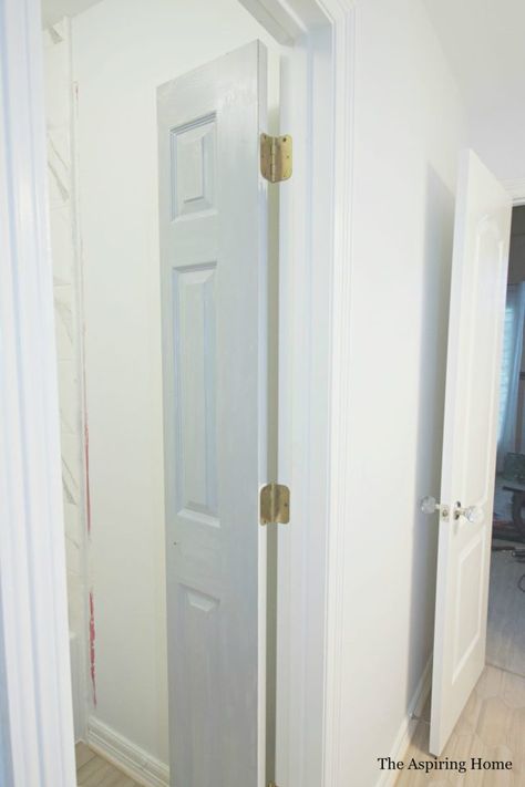 Easily solve a bathroom door issue by creating DIY petite double doors from bifold doors with this quick tutorial! Sometimes, when revamping a space, it takes more than paint and tile choice. It takes creative problem solving. I have found this to be true whether I am dealing with old or new construction. Case in point, this project. Read more on how the DIY petite double doors from bifold doors tutorial solved my issue and created much needed character.   When I sat down to pull… Sliding Double Doors Interior Small Spaces, Bifold Accordion Doors, Bathroom French Doors Small, Paint Bifold Doors, Bathroom Closet Door Ideas Small Spaces, Bifold Door For Bathroom, Vertical Split Door, Tiny Bathroom Door Ideas, Small Space Door Ideas