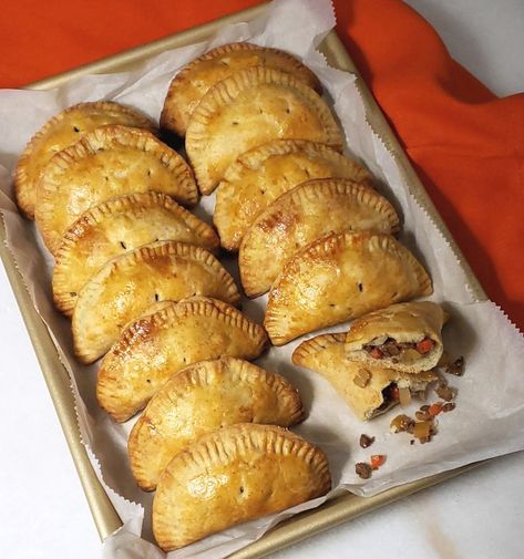 Opening Day Michigan Pasties - A baking sheet is lined with these piping hot hand-held meat and vegetable pies. Golden, flaky, half-moon shaped pies are bursting with seasoned ground beef, potatoes, rutabaga, onion and carrots (option for meatless version is provided in the recipe). Pasty Recipe Michigan, Michigan Pasties, Turnip Vegetable, Pasties Recipes, Big Buck, Hand Pie, Meat Pies, Portable Food, Wait What