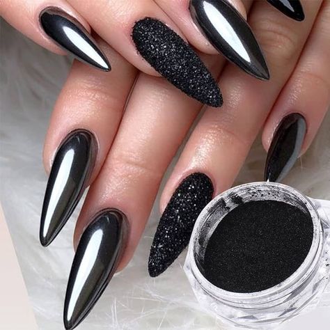 This dramatic nail design features a unique combination of textures, mixing a glossy chrome finish with matte black accents. The stiletto shape enhances the boldness, while the textured black nail adds depth and dimension to the overall look. . Ideal for parties, events, or simply making a statement, these nails offer a high-contrast, high-impact style that exudes confidence and creativity. Chrome Nails Ideas, Sparkly Black Nails, Almond French Tips, Cross Nail Designs, Black Chrome Nails, Matte Stiletto Nails, Ombre Chrome Nails, Gold Chrome Nails, Metallic Nail Art