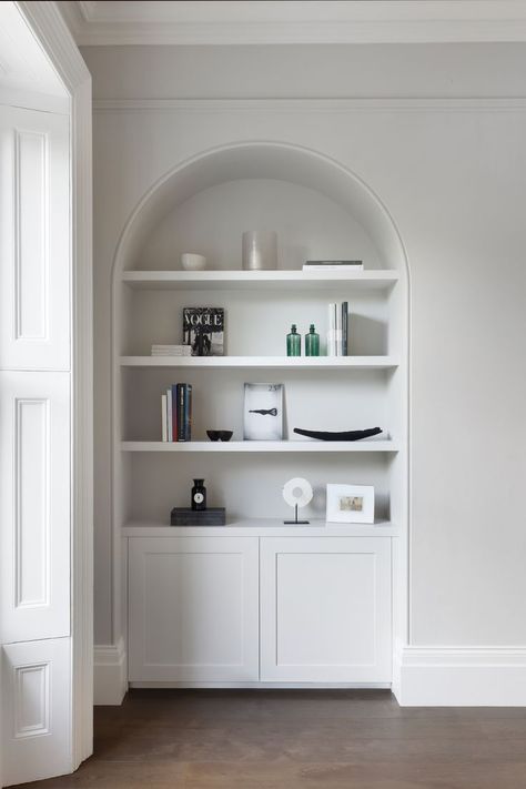 This convenient cove shelving provides both storage access and an inkeeping aesthetic in Wimbledon, London, by Catherine Wilman Interiors #catherinewilmaninteriors #interiordesign #homeinspo #renovationproject #homedesign #interiors #londoninteriordesigner #interiorstyling #interior #design #beforeafterlondoninteriors #bedroom #bedroominspo #ensuiteinspo #bespokejoinery #renovationproject #londonhomes #interiorinspo #homerenovation Cove Shelving, Arched Alcove, Hallway Wall Ideas, Shelving Design, Hallway Wall, Classic Interiors, Bedroom Remodel, Remodel Inspiration, Apartment Renovation