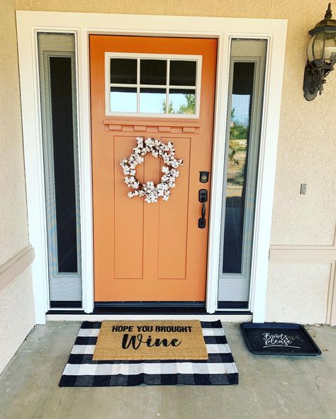 Farmhouse porch with burnt orange front door Front Door Colors Orange, Burnt Orange Exterior Door, Door Colors Brown House, Gray House Orange Door, Orange Trim House Exterior, White House Orange Door, Fun Door Colors Entrance, Tangerine Front Door, Orange Front Door White House