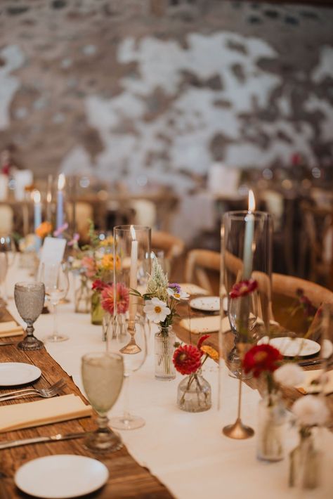 At the reception, each table was adorned with a beige runner, creating a neutral base for the explosion of color that was to come. The table settings were a true testament to the power of details. Beautiful ribbed, pastel chalices added a touch of elegance, while our blush glass votives, with their bumpy, ribbed texture, echoed the delicate intricacy of the glassware. Bud Vase Runner, White Table Runner Wedding, Flower Runner, Glen Mills Pa, Accent Flowers, Dried Flowers Wedding, Glass Votives, 2025 Wedding, Wedding Tablecloths