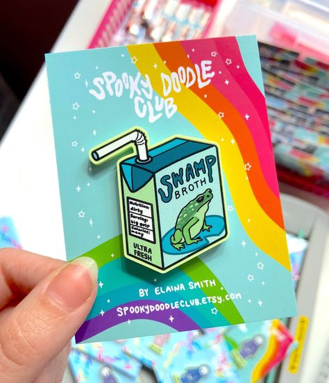 Spooky Doodle Club acrylic pin featuring a swamp broth juicebox. Perfect for fans of spooky and cute things! #spookydoodleclub #spooky #cute #pin . #Juice_Box_Art #Winona_Mn #Cosplay_Wings #Frog_Gifts Enamel Pin Design, Juice Box, Acrylic Pins, Spooky Cute, Pin Design, Mushroom Art, Poster Stickers, Cool Stickers, Cute Packaging