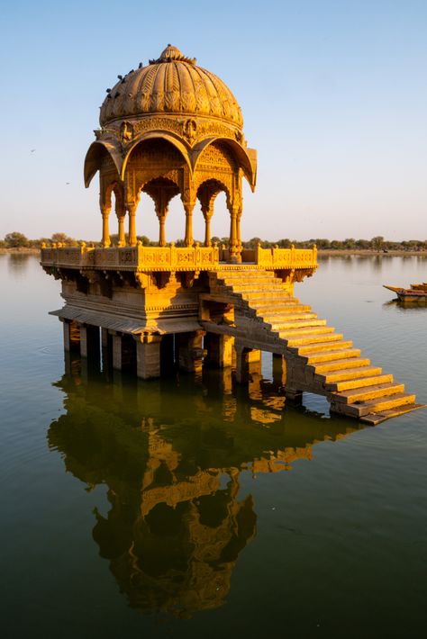 Beneath the shadow of Jaisalmer Fort, India’s Golden City shines in the desert sun. Bustling markets, intricately carved havelis, and golden chhatris above Gadisar Lake mark this ancient city on the edge of the Thar Desert. Tucked in the western corner of Rajasthan between India and Pakistan, the Thar Desert is the largest desert in India. As the sun casts a warm glow over Jaisalmer Fort, the desert beauty of Jaisalmer transcends the passage of time. Golden City Jaisalmer, Gadisar Lake, Jaisalmer Fort, Thar Desert, Desert Beauty, Golden City, Applied Art, Desert Sun, Jaisalmer