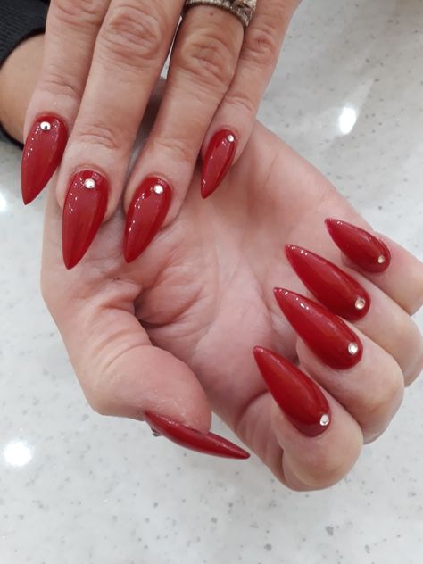 Red pointed nails with diamonds Red Almond Nails With Diamonds, Red And Diamond Nails, Red Almond Nails With Rhinestones, Red Acrylic Nails With Gems, Nails Red With Diamonds, Red Nails With Jewels, Red Pointed Nails, Red Nails With Rhinestones Simple, Short Red Pointy Nails