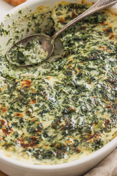 This creamed spinach from frozen spinach is a steakhouse-style recipe that's baked at the end in a casserole dish. It's made without heavy cream but in a creamy, cheesy sauce. It's the perfect side dish for Thanksgiving, Christmas, or holidays and it feeds 8-10 people as written, but can be decreased for a smaller group. The perfect winter potluck dish! Spinach Heavy Cream Recipes, Creamy Spinach Casserole, Southern Creamed Spinach, Creamy Spinach Bake, Creamy Spinach Recipe, Wilted Spinach Recipes, Boursin Creamed Spinach, Spinach Madeline Recipes, Thanksgiving Spinach Recipes