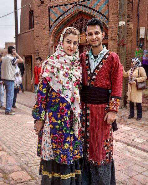 A Persian couple wearing traditional dress of Abyaneh village, in Isfahan. You can choose our village tour to touch the pure Iranian culture still alive in villages. https://www.irandestination.com/tour/iran-villages-tour/  #Iranvillage  #Irantravelagent #Irandestination #Irantravelagency #Irantourpackages #Persiantravelagency #Irantravel #traveltoIran   #coupletravel #halaltravel #Iran #traditionaldress #abyaneh #redvillage Iran Clothes, Traditional Iranian Clothing, Iran Outfit, Iran Clothing, Iranian Clothes, Persian Dress, Persian People, Persian Women, Iran Culture