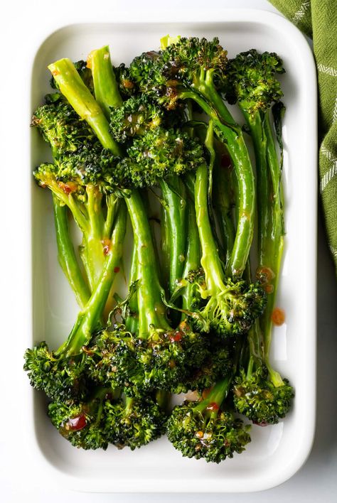 Top down oven roasted broccolini recipe with sweet chili glaze stacked on a white rectangle serving platter. Best Way To Cook Broccolini, Brocollini Recipes Roasted, Oven Roasted Broccolini Recipe, Brocolini Recipes Oven, Broccolini Recipe Side Dishes, Brocollini Recipes, Roasted Broccolini Recipe, Brocolini Recipes, Broccoli Rabe Recipe