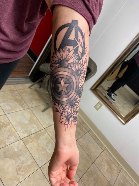 Marvel's Captain America tattoo Marvel Sleeve Tattoo Woman, Marvel Tattoo Women, Marvel Tattoos Quotes, Marvel Tattoos With Flowers, Marvel Art Tattoo, Marvel Half Sleeve Tattoo, Marvel Tattoos Captain America, Marvel Floral Tattoo, Marvel Watercolor Tattoo