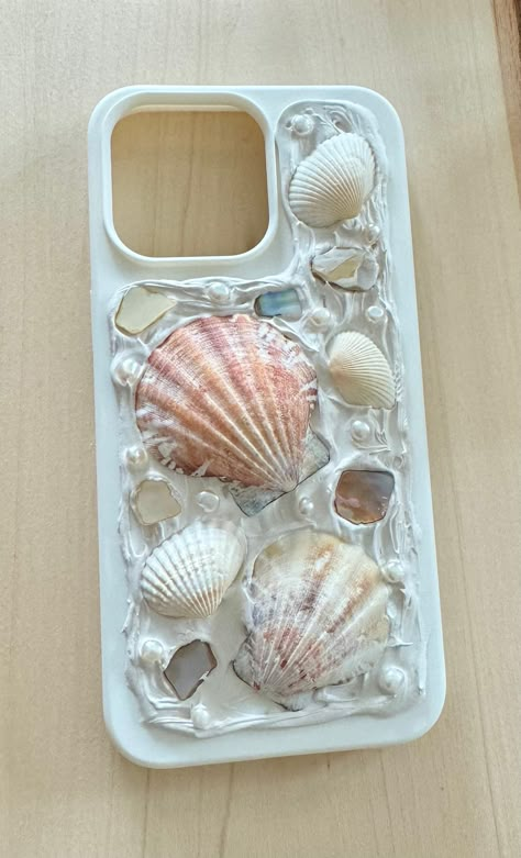 This is a white phone case with different shells and freshwater pearls. Once your order is placed your phone case will be designed with similar shells and pearls. Due to each shell and pearl having different properties to them, please keep in mind your phone case will look slightly different but just as beautiful as the one shown here. This is the perfect gift for the beach lover! please note that this phone case is delicate and should be handled with care. We would advise you not to get this ph Diy Shell Phone Case, Shells And Pearls, Telephone Cases, Casetify Cases, Mermaid Core Phone Case, Shell Iphone Case, Ocean Room Decor, Sea Shell Phone Case, Seashell Phone Case