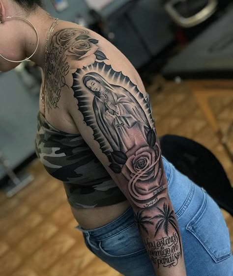 165+ Spectacular Virgin Mary Tattoos With Meaning (2022) - TattoosBoyGirl Virgin Mary Shoulder Tattoo, Chicana Tattoos For Women Sleeve, Places To Get Name Tattoos, Full Shoulder Tattoos For Women, Virgen De Guadalupe Tattoo Ideas Women, Virgen Mary Tattoo For Women, Upper Breast Tattoo For Women, Virgin Mary Tattoo For Women, Virgin De Guadalupe Tattoo Ideas