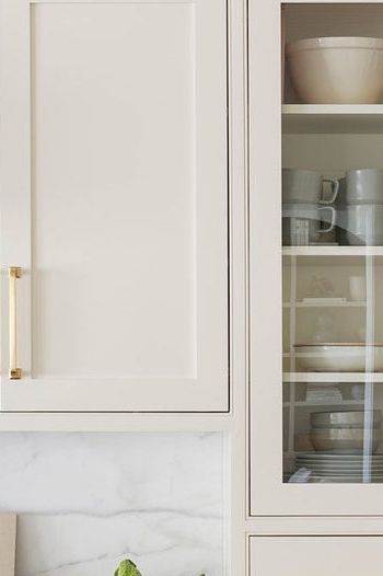 The question of which is the best white paint for kitchen cabinets is an age-old debate, so we asked designers to share their favorite swatches. Off White Paint Colors For Cabinets, White Down Cabinets, White Walls Greige Cabinets, Soft Beige Cabinets, Cream Kitchen Cabinet Paint Colors, Cabinet Colors With Carrara Marble, Sherwin Williams Dover White Kitchen Cabinets, Framed Cabinets Kitchen, Oxford Cream Paint