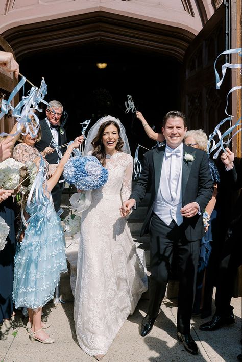 A bride and groom exit doors of the church, surrounded by flower girls, family and guests holding blue and ivory streamers in celebration Ribbon Wedding Send Off, Ribbon Wedding Exit, Church Exit Wedding Ideas, Wedding Streamers, Wedding Recessional, Nz Beach, Wedding Photography Shot List, Wedding Flags, Wedding Exit