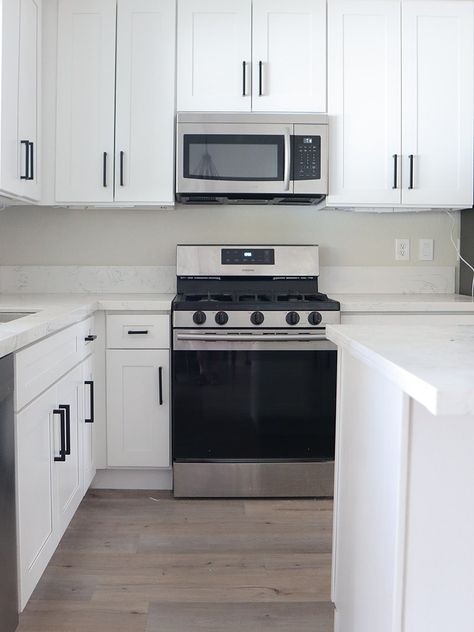 How One Couple Revamped Their Builder-Grade Kitchen Without Touching the Cabinets Builder Grade Kitchen Makeover, Cream Tile Backsplash, Builder Grade Kitchen, Kitchen Looks, Renovation Budget, Countertop Surfaces, Brass Trim, Builder Grade, Parisian Vibes