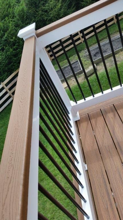 Natural Wood Deck With Black Railing, Brick House With Deck, Basement Landscaping Ideas, Trex Patio Ideas, Trex Railing Ideas, Trex Handrails, Trex Front Porch Ideas, Trek Deck Ideas, Trex Deck Ideas Color Schemes