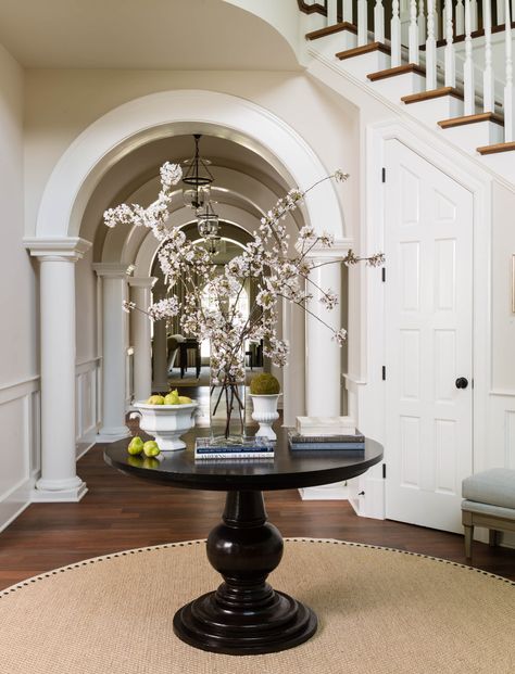 Entrance Hall Round Table, Foyer Ideas Entryway Traditional, Hallway Round Table, Round Table Foyer, Foyer Decorating Curved Staircase, Round Entry Table Stairs, Round Table Foyer Entryway Stairs, Curved Staircase Foyer Entryway Decor, Large Foyer Ideas Entryway