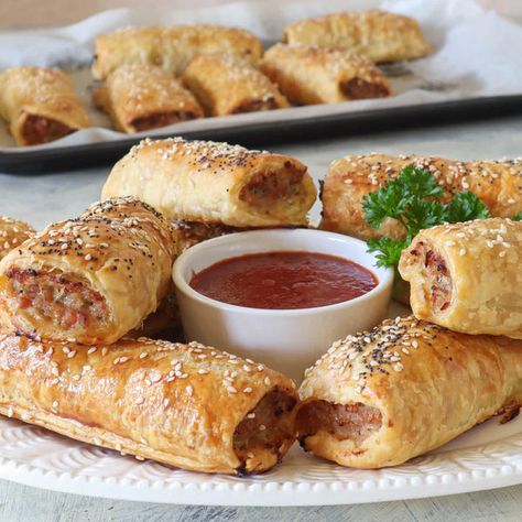 Australia’s favourite party food made with freshly ground pork.Juicy sausage mixture wrapped in golden flaky pastry, otherwise known as ‘sausage rolls’ are a classic Australian snack. Even though they technically originate in the UK, t... Australian Snacks, Hot Sausage, Flaky Pastry, Sausage Rolls, Pork Sausage, Saute Onions, Ground Pork, Bagels, Chutney