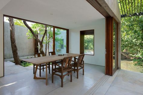 House on a Stream in Alibag, India, by Brio Architects/Remodelista//multitrack sliding system India Architecture, Wood And Concrete, Timeless Architecture, Retreat House, Peaceful Living, Internal Courtyard, Open Dining Room, Weekend House, Outdoor Dinner