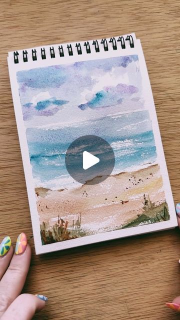 Kristin Van Leuven | Watercolor artist and instructor on Instagram: "Quick watercolor beach sketch to show you that your watercolor practice can be quick and messy with very little detail and still be beautiful!  I have been loving these watercolor paints #gifted to me by @winsorandnewton . The colors are so beautiful and immediately reminded me of the beach and so I had to do a quick sketch!   The key with loose watercolor beaches is that lovely dry brush technique where you swipe the body of the brush flat against the paper. Then the texture of the paper will pop out and reveal areas that look like the perfect sparkle on the water, or rough texture in the sand.   Try out this quick and fun beach technique and tag me! I would love to see and share 💕" How To Paint A Beach, Watercolor Seascapes Tutorial, Simple Beach Watercolor, Watercolor Beach Tutorial Step By Step, Easy Watercolor Paintings Tutorials, Watercolor Beach Tutorial, Sea Beach Painting Watercolor, Watercolor Beach Scenes, Beach Watercolor Paintings