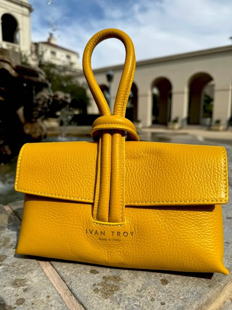 Aria Italian Leather bag is exquisite Ivan Troy Wrist Italian Leather Handbag, a true embodiment of luxury and style. Crafted from the finest Italian leather, this handbag exudes elegance and sophistication. The unique design features a convenient wrist strap that allows for effortless carrying and keeps your hands free. Experience the ultimate combination of timeless beauty and practicality with the Ivan Troy Wrist Italian Leather Handbag. This versatile clutch effortlessly combines sophisticat Clutch Leather Bag, Unique Purses And Handbags, Unique Bags Design, Yellow Bags, Unique Leather Bag, Yellow Purse, Leather Bag Design, Luxury Tote Bags, My Style Bags