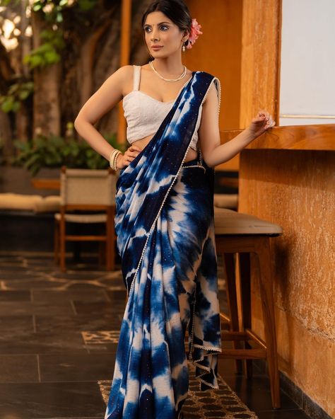 Discover the elegance of our Stylish Navy Blue Shibori Georgette Saree, featuring beautiful sequenced crochet and minimal pearl lace embellishments. Crafted from high-quality georgette fabric, it highlights your figure with a touch of sophistication. Perfect for any occasion, this saree will make you stand out with its unique design and elegant detailing. #sujatra #sujatraglobal #sujatrasarees #georgettesaree #shibori #shiborigeorgette #pearllace #crochet #sequenced #shiboridye #navyblue #bl... Shibori Sarees, Lace Embellishments, Lace Saree, Pearl Lace, Shibori Dye, Pearl And Lace, Georgette Saree, Georgette Fabric, Georgette Sarees